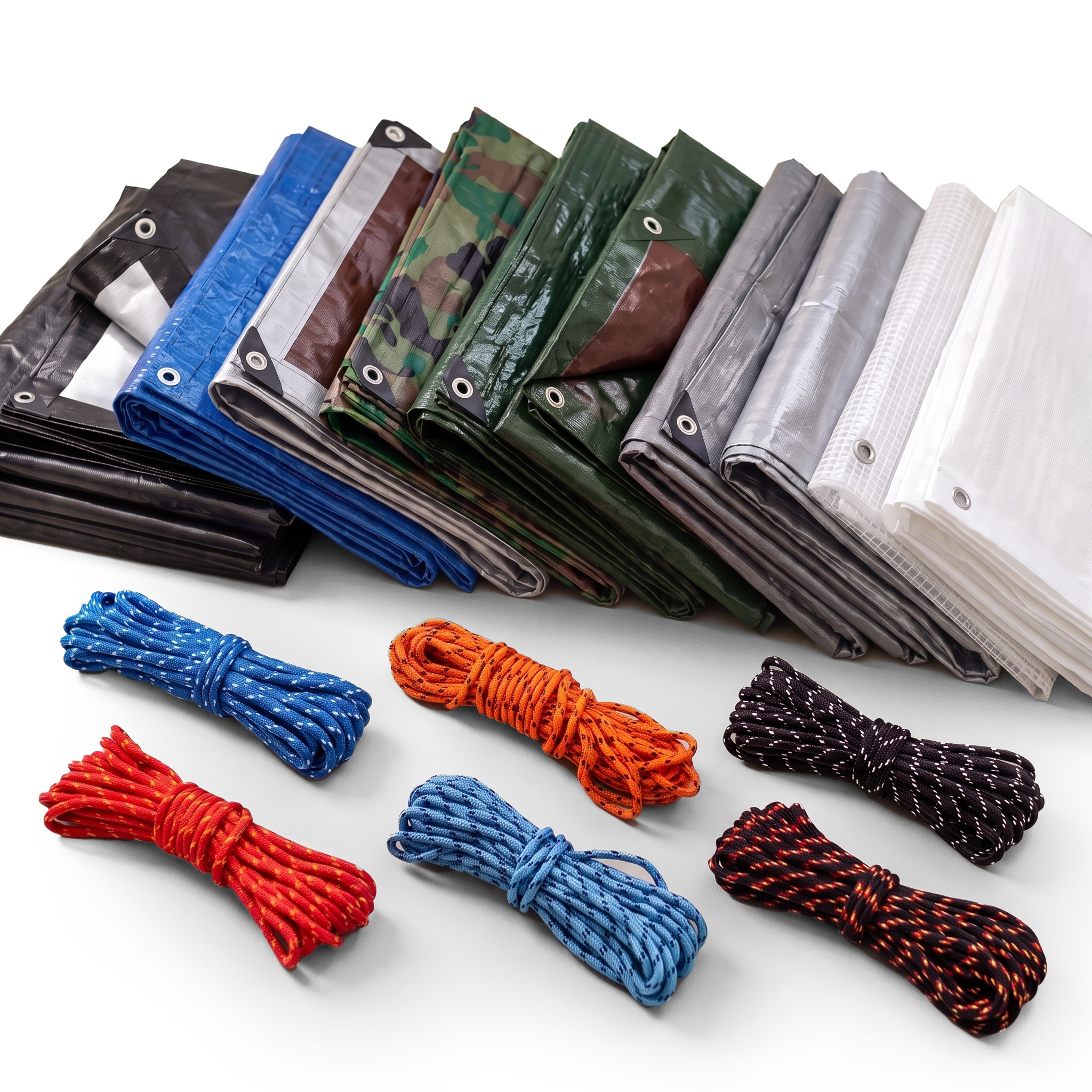 Folded tarpaulins in assorted colours with metal eyelets and coils of braided rope