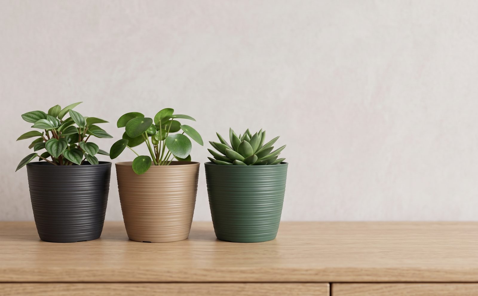 Anthracite, caramel and pine green ribbed pots on an oak sideboard with three icons