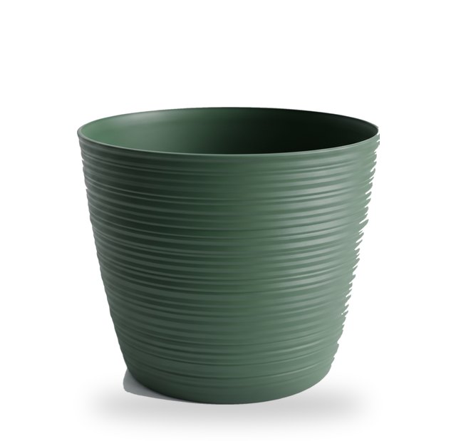 Empty pine green ribbed plant pot in the 14 cm size, on a light background