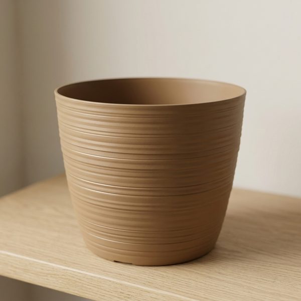 Close-up of the fine horizontal ribbing on an empty caramel plant pot