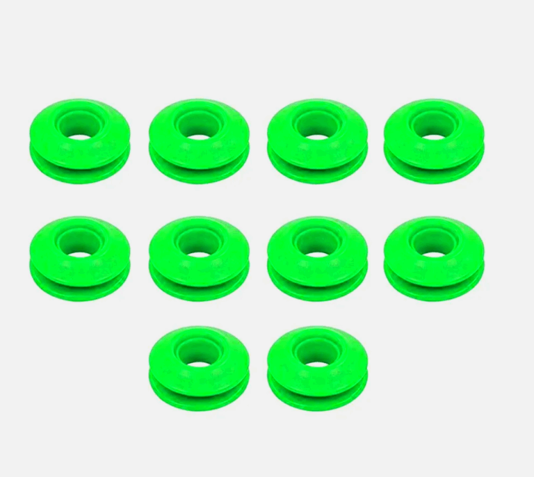 Green plastic snap eyelets arranged in rows on a white background