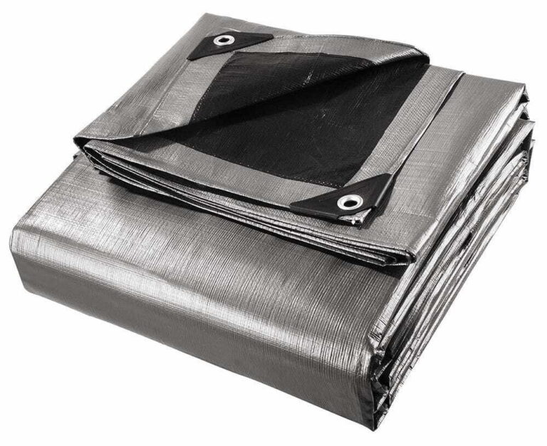 Folded silver and black tarpaulin with metal eyelets and reinforced corner patches