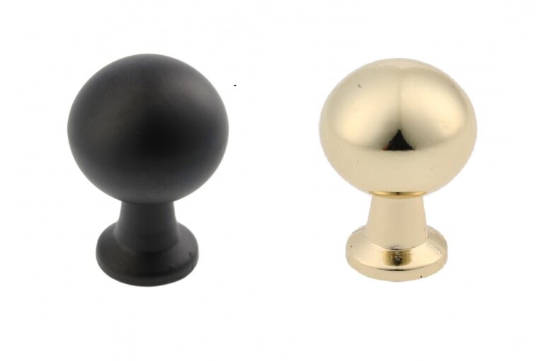 Round Nord cabinet knobs in matt black and brass-coloured finishes