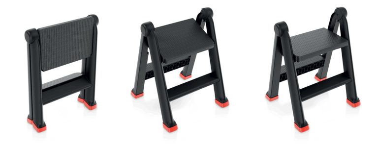 Black folding two-step stool with red foot caps, shown folded and open