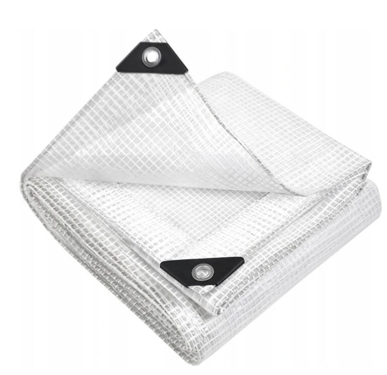 Folded clear tarpaulin with a white grid pattern, black corner patches and metal eyelets