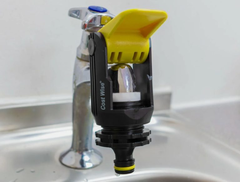 Yellow and black clamp-style hose adaptor fitted over a chrome indoor tap spout